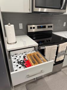 a kitchen with an open drawer with knives at A place to call a home in YYC