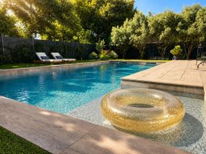 a swimming pool with a gold ring in the middle at Suite neuve piscine privée Les Charmettes in La Ciotat +16 photos