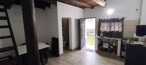 a room with a hallway with a table and a door at El Refugio - Departamentos in Metán Viejo