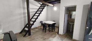 a room with a table and chairs and a ladder at El Refugio - Departamentos in Metán Viejo