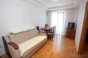 a living room with a couch and a table at Apartmani Cebra & Lisa in Topla