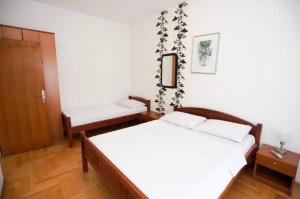 a bedroom with a bed and a bench in it at Apartmani Cebra & Lisa in Topla