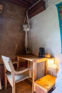 a wooden table with a chair and a desk at Aloha Riverside in Kasol