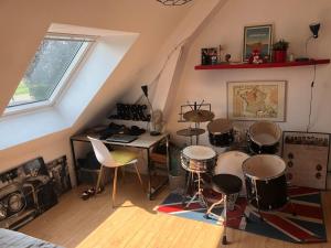a room with drums and a desk in a attic at Single-storey house in Saint-Cyr in Saint-Cyr-sur-Loire
