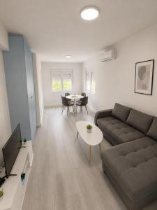 a living room with a couch and a table at White House apartmani in Vrdnik