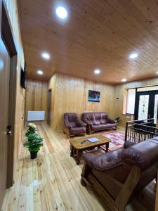 a living room with leather couches and a table at Kazbegi Vibe in Kazbegi +23 photos