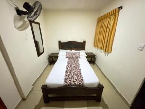a bedroom with a bed in a room at Hotel Tucan Pereira in Pereira