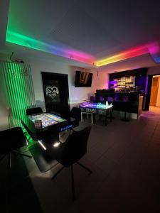 a living room with green and purple lights at emsRoom - Gästezimmer in Düne +11 photos