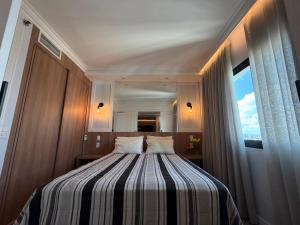 a bedroom with a bed with a large window at Hotel Inter Jardins UH-2310 in São Paulo +15 photos