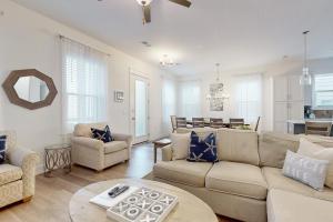 a living room with a couch and a table at New-Build with Pool Walk to Beach in Santa Rosa Beach