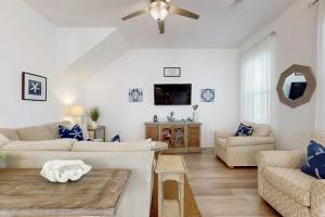 a living room with a couch and a ceiling fan at New-Build with Pool Walk to Beach in Santa Rosa Beach