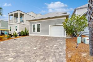 a large house with a garage in front of it at New-Build with Pool Walk to Beach in Santa Rosa Beach