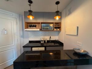 a kitchen with a sink and a counter top at Hotel Inter Jardins UH-2310 in São Paulo