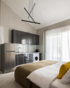 a bedroom with a bed and a kitchen at Sakis 2 in Polychrono