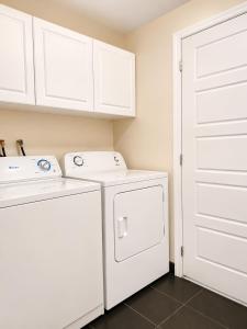 a white laundry room with a washer and dryer at APARTMENT HOTEL ST-DENIS in Montreal +61 photos