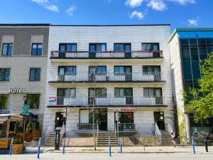 an apartment building with a balcony on a street at APARTMENT HOTEL ST-DENIS in Montreal