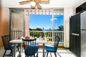 a dining room with a table and chairs and a large window at Mer et plage Standing Presta in Cannes