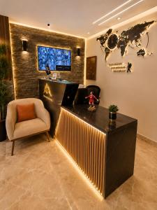 a lobby with a reception desk and a chair at Sunshine Pyramids Hotel & Restaurant in Cairo