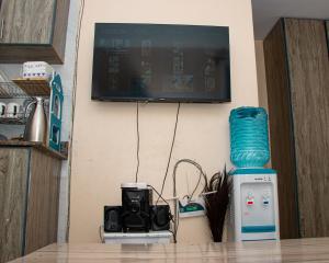 a television on a wall with a camera on a table at Delore suits in Ongata Rongai  +5 photos