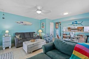 a living room with a couch and a table at Spacious 2BR Condo with Pool Across from the Beach in Gulf Shores