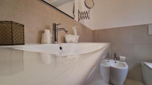 a bathroom with a sink and a urinal at Venti del Sud in Vieste +36 photos