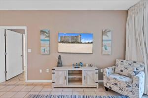 a living room with a chair and a table at 3BR 4BA Ground Floor Gulf Getaway in Gulf Shores