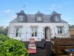 a house with a red and white rug in front of it at Chez Billie et Moon in Landéda