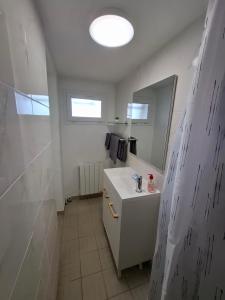a bathroom with a white sink and a mirror at La Champêtre in Beaumesnil +20 photos
