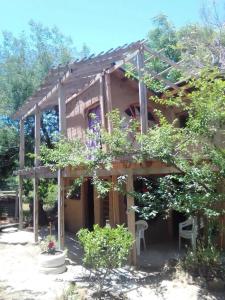 a house with a pergola in a garden at Amor pisciano 1 in Salinas