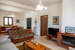 a living room with a couch and a fireplace at Villa Santa Lucia in Noto