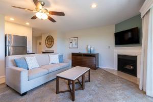 a living room with a couch and a fireplace at Villa L'Auberge in San Diego