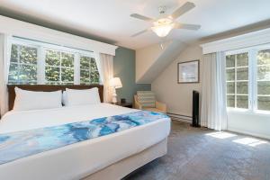 a bedroom with a large bed with a ceiling fan at Villa L'Auberge in San Diego +46 photos
