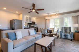 a living room with a couch and a kitchen at Villa L'Auberge in San Diego