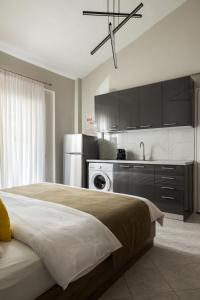 a bedroom with a large bed and a kitchen at Sakis in Polychrono