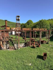 an old train in a field with a sign on it at C'era una volta in Abbadia San Salvatore