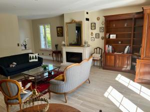 a living room with a couch and a table at Domaine de la Brême in Bréménil