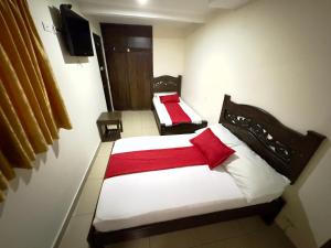 a hotel room with two beds and a flat screen tv at Hotel Tucan Pereira in Pereira +65 photos