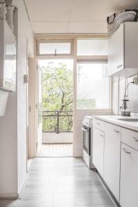 a kitchen with a door leading to a balcony at The Hague appartment in The Hague