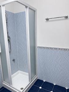 a shower with a glass door in a bathroom at Le case di Rebecca in Palermo +21 photos