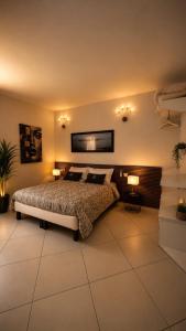 a bedroom with a bed with two lights on the wall at Gan Eden B&B in Monterenzio