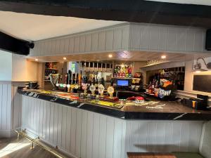 a bar with a counter with a lot of alcohol at The Royal George Cottingham in Cottingham