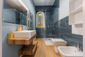 a bathroom with a sink and a toilet and a shower at Villa Domina by Letstay in Giardini Naxos