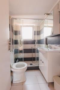 a bathroom with a toilet and a shower and a sink at Zoumperi Summer House in Nea Makri