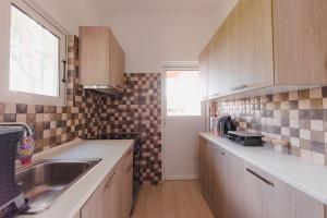 a kitchen with a sink and a counter top at Zoumperi Summer House in Nea Makri