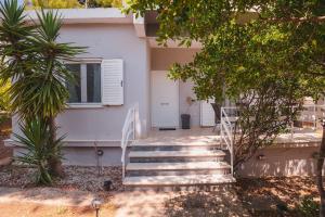 a set of stairs leading to a house at Zoumperi Summer House in Nea Makri