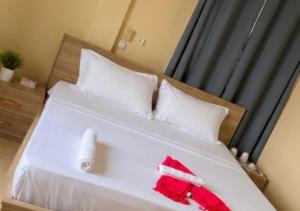 a bed with a red santa hat on it at Lilia Business Hotel in Ouagadougou +7 photos