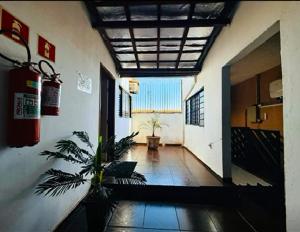 a hallway of a building with a plant in it at Pousada Anhanguera in Ribeirão Preto