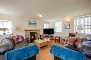 a living room with two couches and a fireplace at 2 Bed in Eyemouth oc-77427 in Ayton