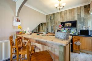 a kitchen with a counter with a table and chairs at 2 Bed in Eyemouth oc-77427 in Ayton