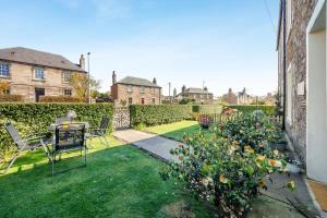 a garden with a table and chairs and flowers at 2 Bed in Eyemouth oc-77427 in Ayton